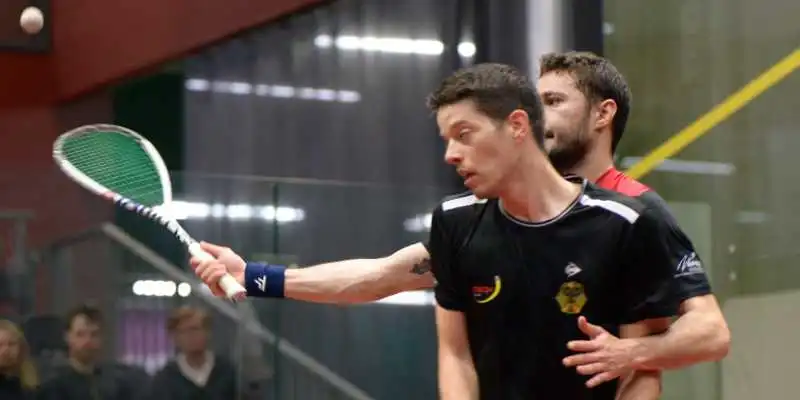 Two players getting close to each during a squash match